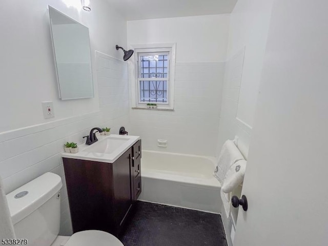 bathroom with vanity, a wainscoted wall, bathtub / shower combination, tile walls, and toilet