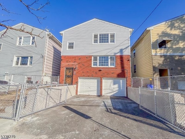 view of front of home featuring brick siding, concrete driveway, a garage, and fence