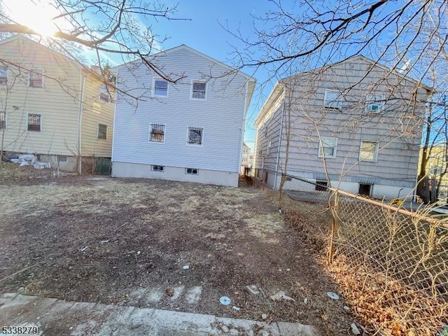 back of house with fence