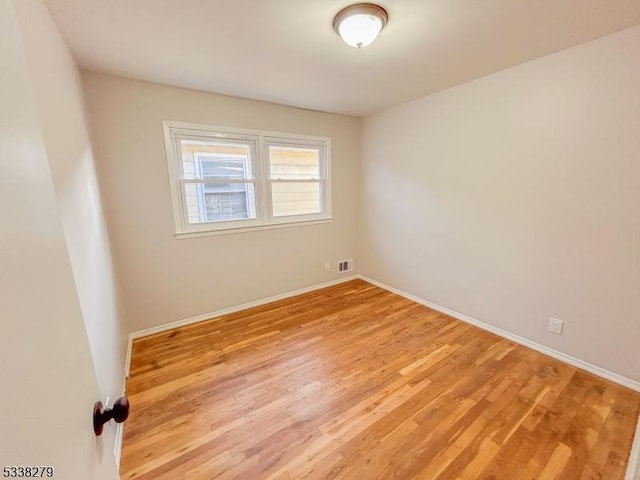 unfurnished room with visible vents, baseboards, and light wood finished floors