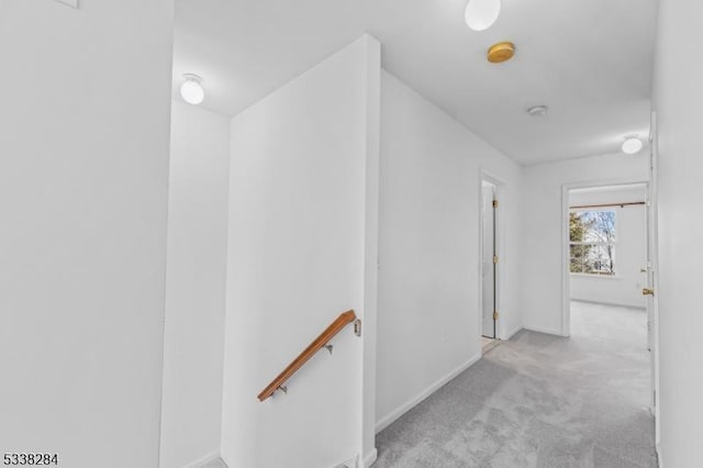 hallway featuring light colored carpet