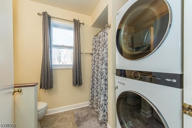 laundry room with stacked washer / drying machine