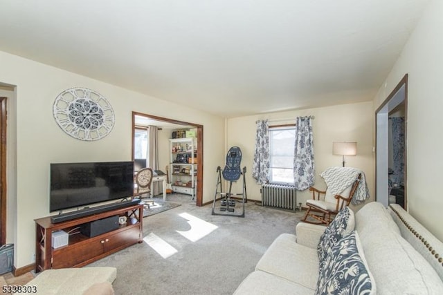 living room featuring radiator heating unit and light colored carpet