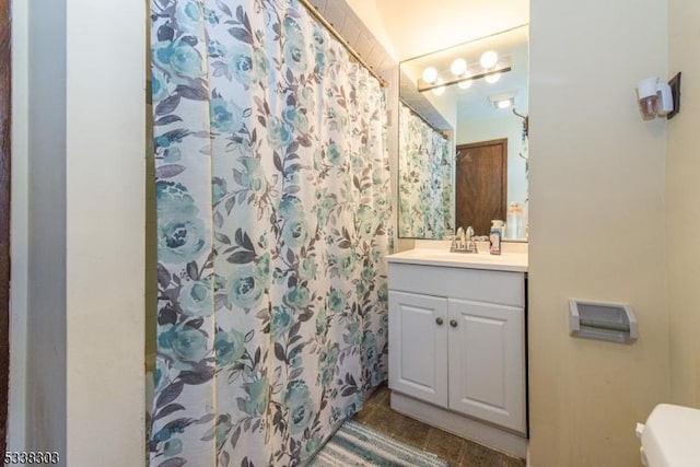 bathroom with a shower with curtain, tile patterned floors, and vanity