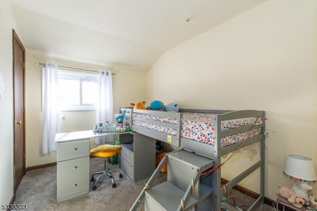 carpeted bedroom with lofted ceiling