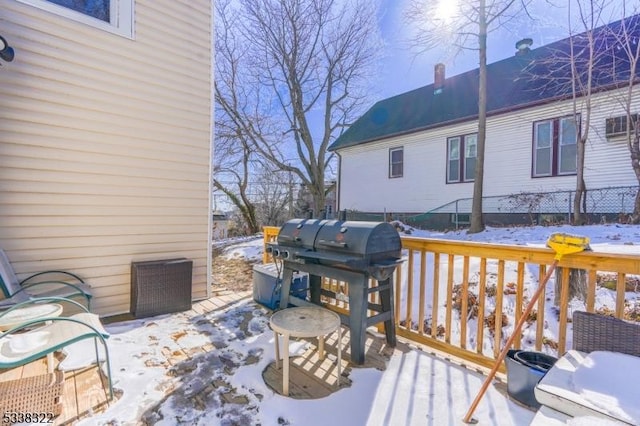 snow covered deck featuring grilling area