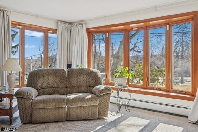 sunroom with a baseboard heating unit and plenty of natural light