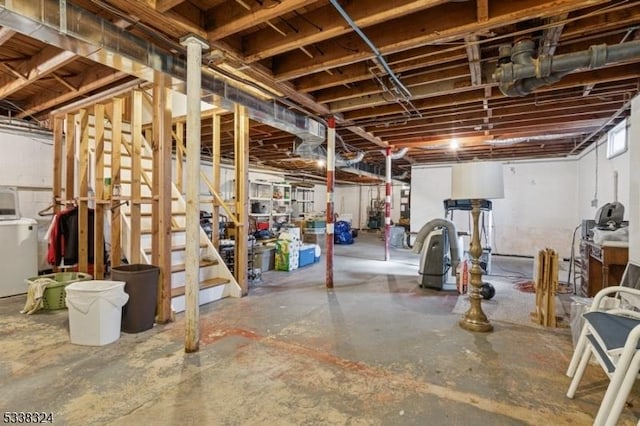 unfinished basement with washer / clothes dryer