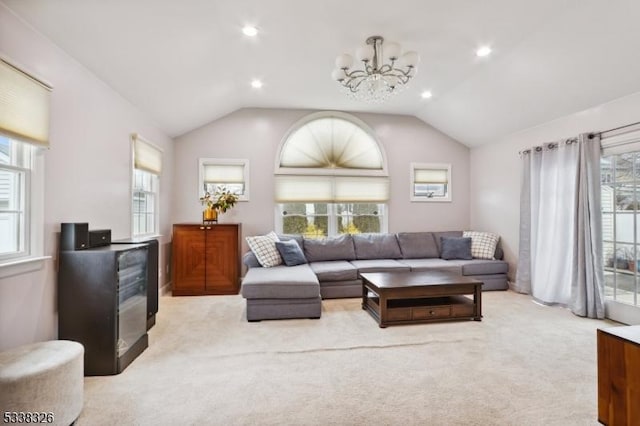 living area with vaulted ceiling, recessed lighting, light carpet, and a notable chandelier