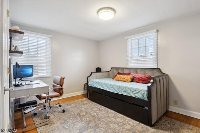 bedroom featuring baseboards and wood finished floors