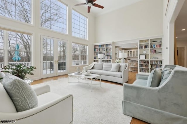 sunroom with a ceiling fan and french doors