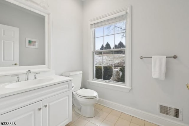 bathroom with visible vents, toilet, vanity, tile patterned flooring, and baseboards