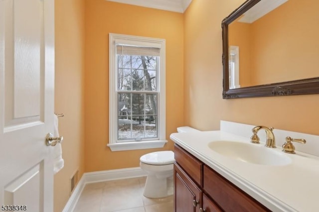 half bathroom featuring toilet, visible vents, baseboards, vanity, and tile patterned floors