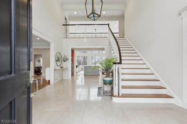 tiled foyer entrance with baseboards, stairs, a high ceiling, crown molding, and recessed lighting