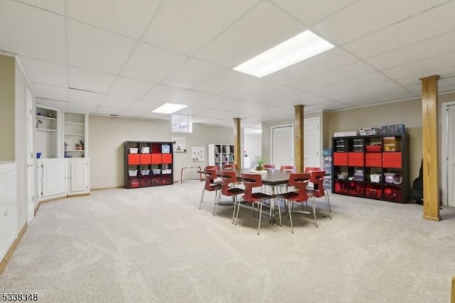 dining area with built in features, carpet, and a paneled ceiling