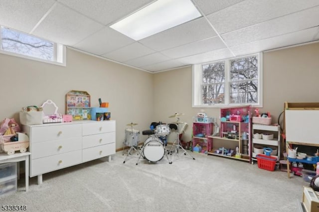 game room with a paneled ceiling and carpet flooring