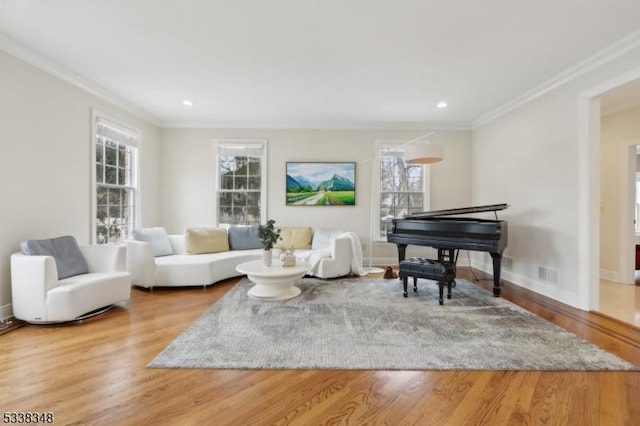 living area featuring ornamental molding, wood finished floors, and visible vents