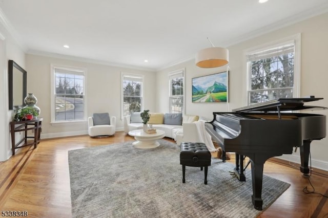 living area with ornamental molding, recessed lighting, wood finished floors, and baseboards