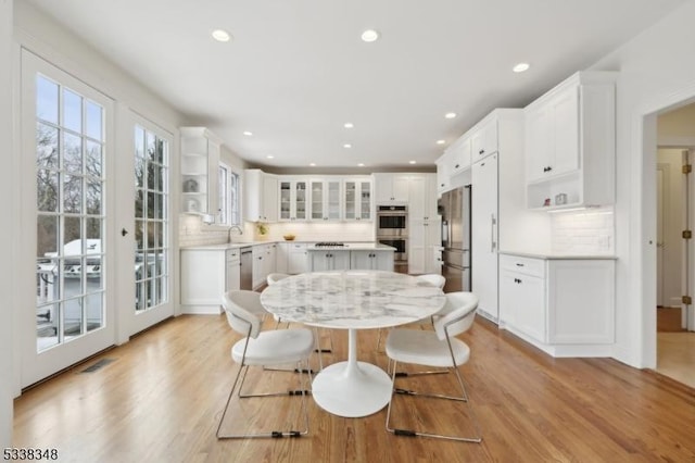 dining area featuring light wood-type flooring and recessed lighting