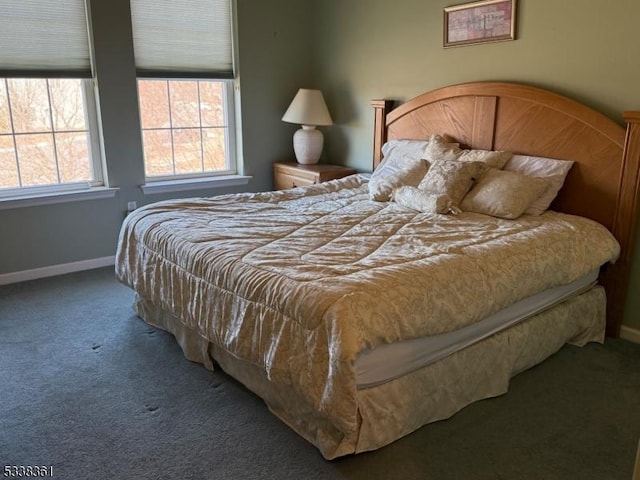 bedroom with dark colored carpet