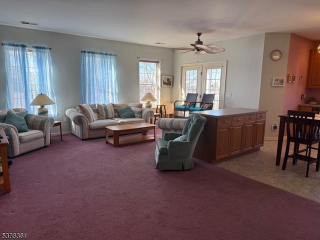 carpeted living room with ceiling fan