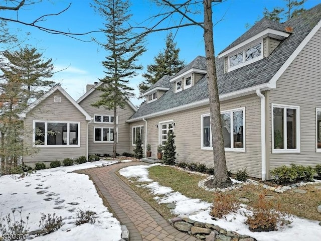 exterior space featuring roof with shingles