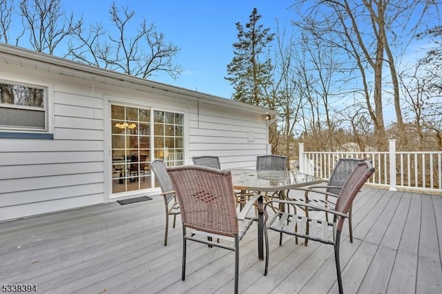 wooden terrace with outdoor dining space