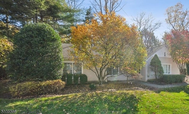 view of side of home featuring a lawn