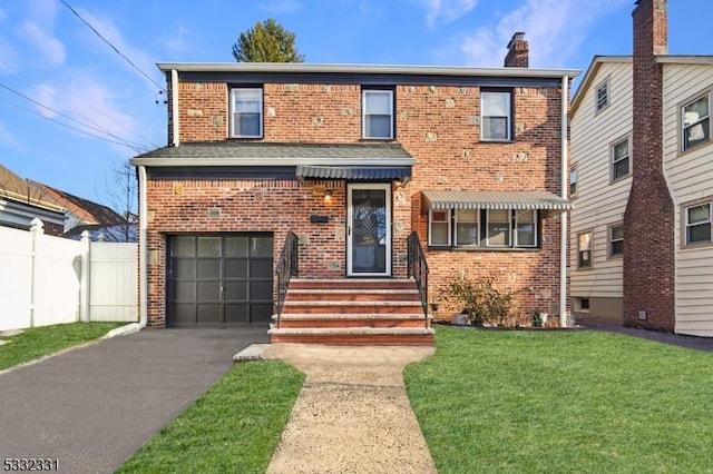 view of front property featuring a garage and a front lawn