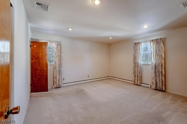 spare room featuring light colored carpet