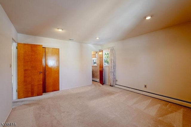 spare room featuring carpet floors and baseboard heating