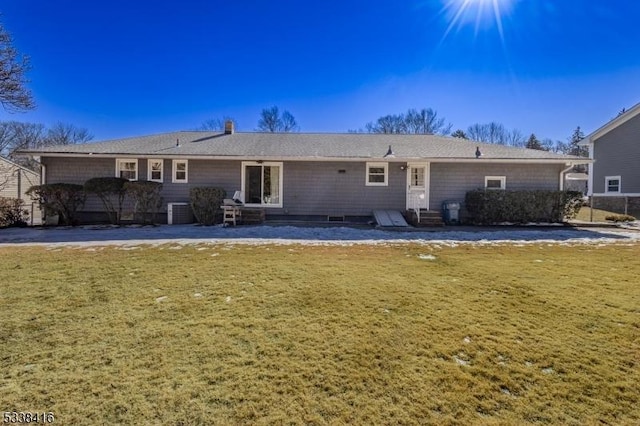 back of property with a lawn and central air condition unit