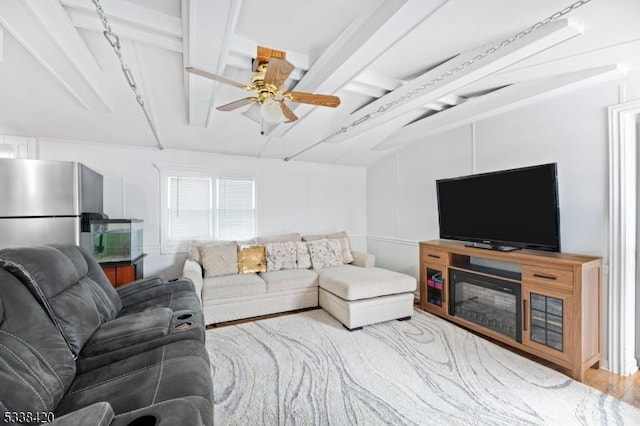 living room with light hardwood / wood-style flooring, ceiling fan, and lofted ceiling with beams