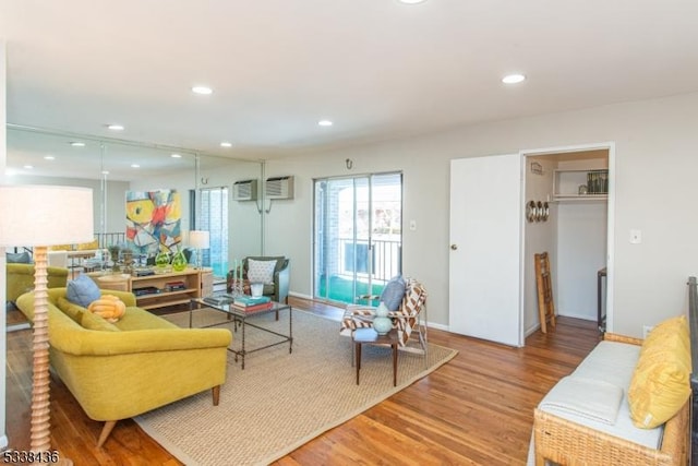 living room featuring wood-type flooring and a wall mounted AC