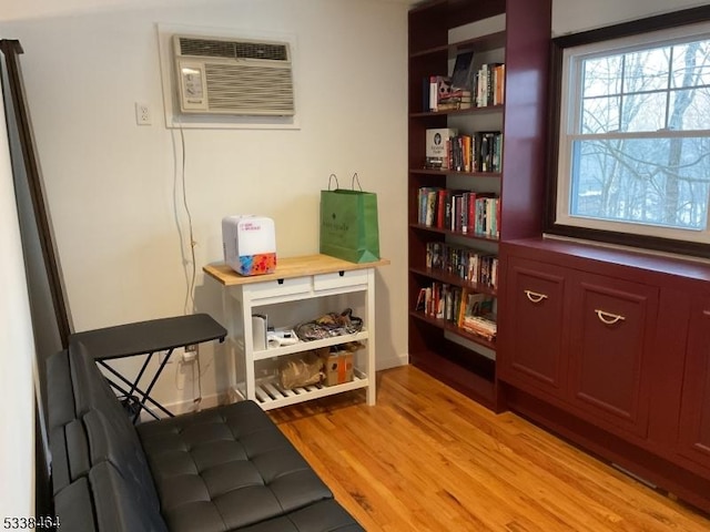 interior space with an AC wall unit and light wood-type flooring