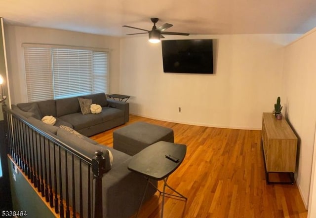 living room featuring ceiling fan and hardwood / wood-style floors