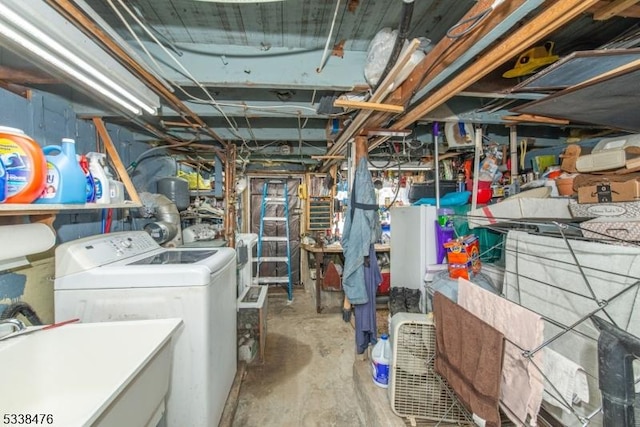 unfinished below grade area with a sink and independent washer and dryer