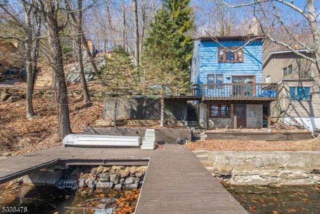 rear view of house featuring a deck