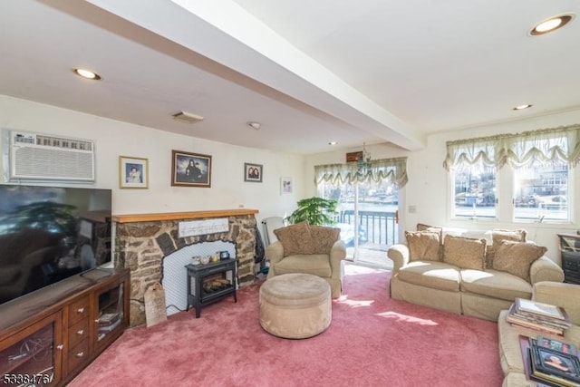 living room with beam ceiling, a wood stove, carpet, and a wall mounted air conditioner