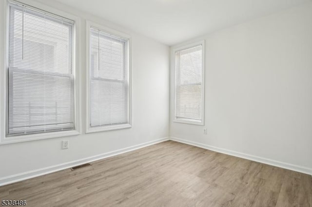 spare room featuring light wood-type flooring