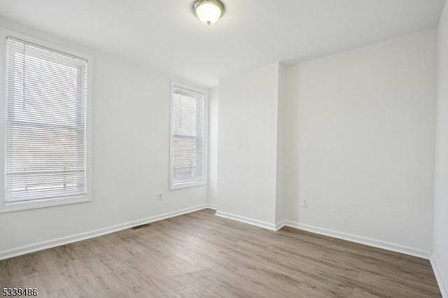 spare room featuring hardwood / wood-style floors