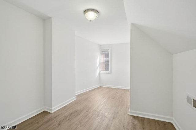 additional living space featuring light hardwood / wood-style floors