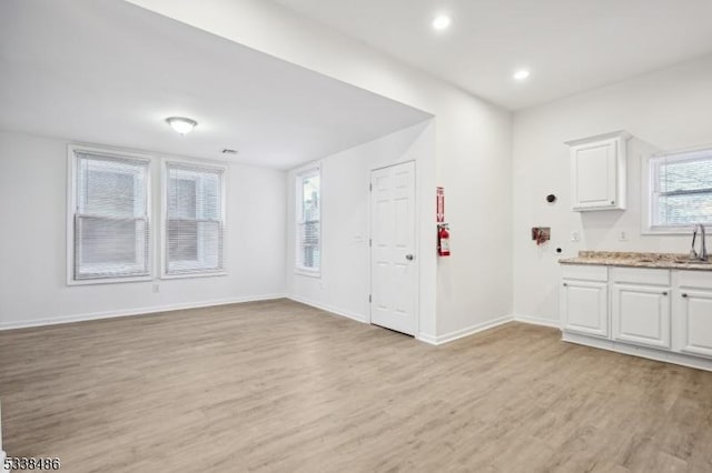 interior space with sink and light wood-type flooring