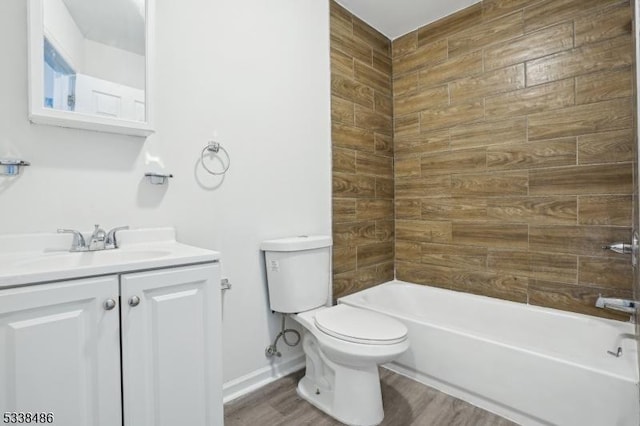 full bathroom featuring toilet, vanity, hardwood / wood-style floors, and tiled shower / bath