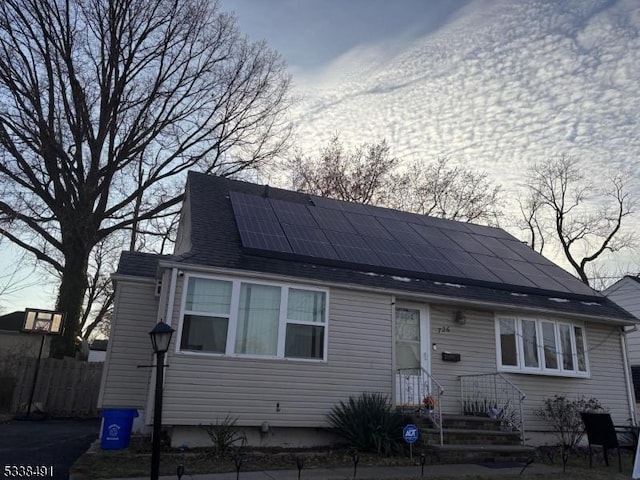 view of front of property featuring roof mounted solar panels