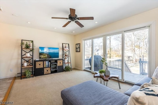 carpeted living room with baseboard heating and ceiling fan