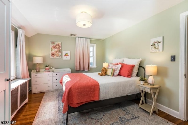 bedroom featuring vaulted ceiling and dark hardwood / wood-style floors