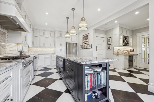 kitchen with custom range hood, decorative light fixtures, a center island, sink, and white cabinetry