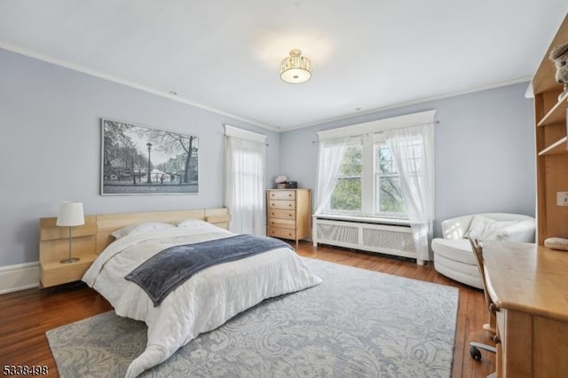 bedroom featuring dark hardwood / wood-style flooring, radiator, and ornamental molding