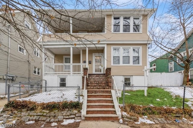 view of front of home featuring covered porch and a fenced front yard